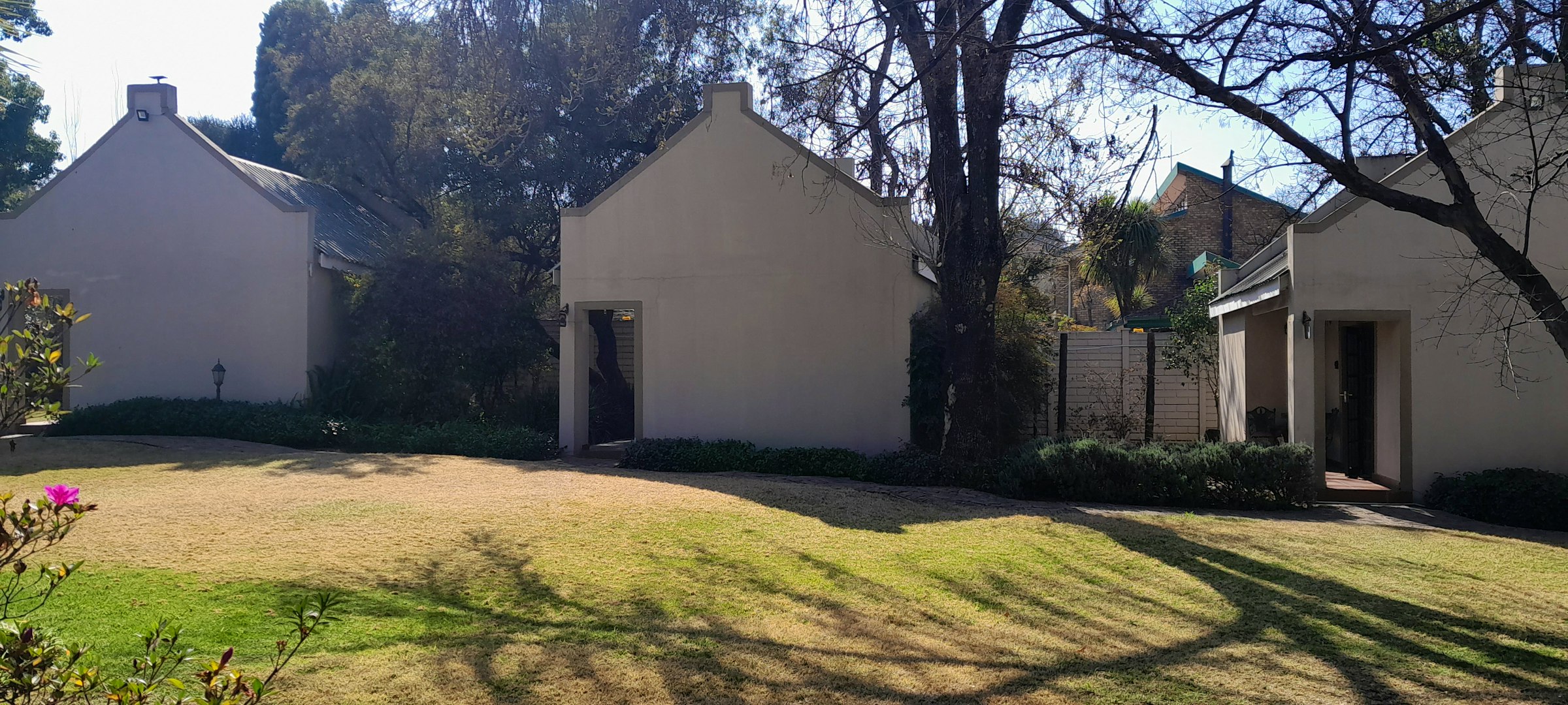 Guesthouse cottages and lawn at Amadeus Guesthouse